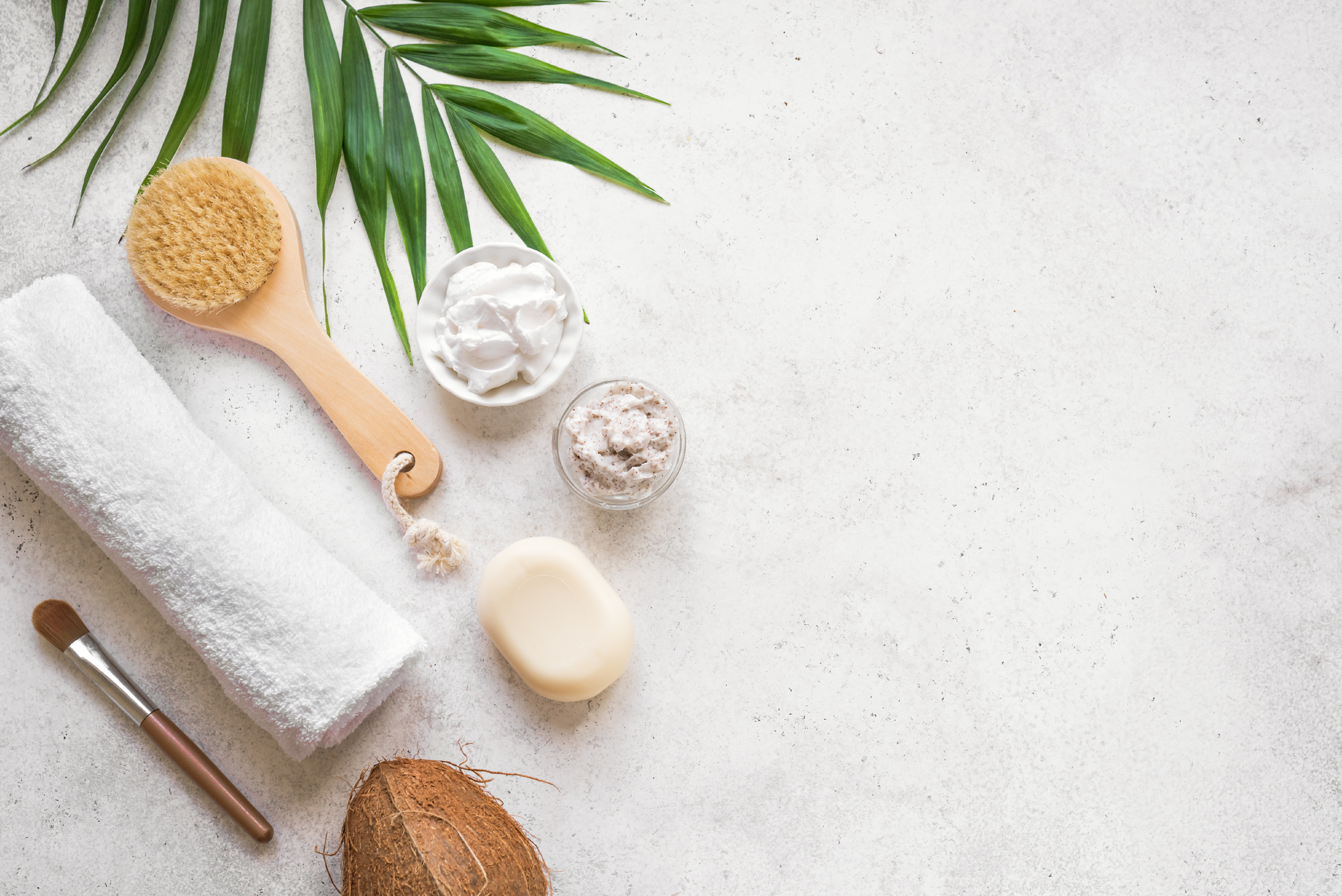 Coconut Spa composition, flat lay, copy space. Natural spa coconut cosmetics and organic treatment concept on white, copy space.