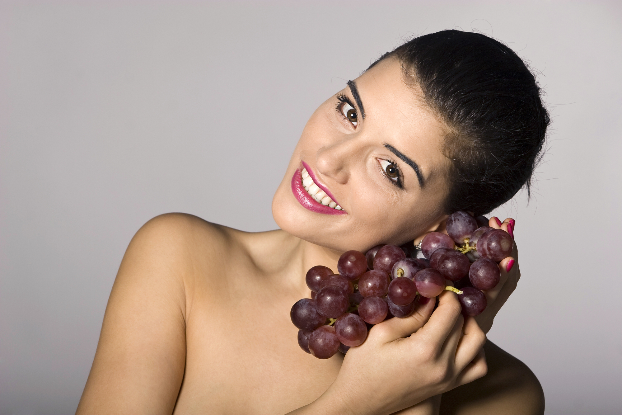 Woman holding red grapes