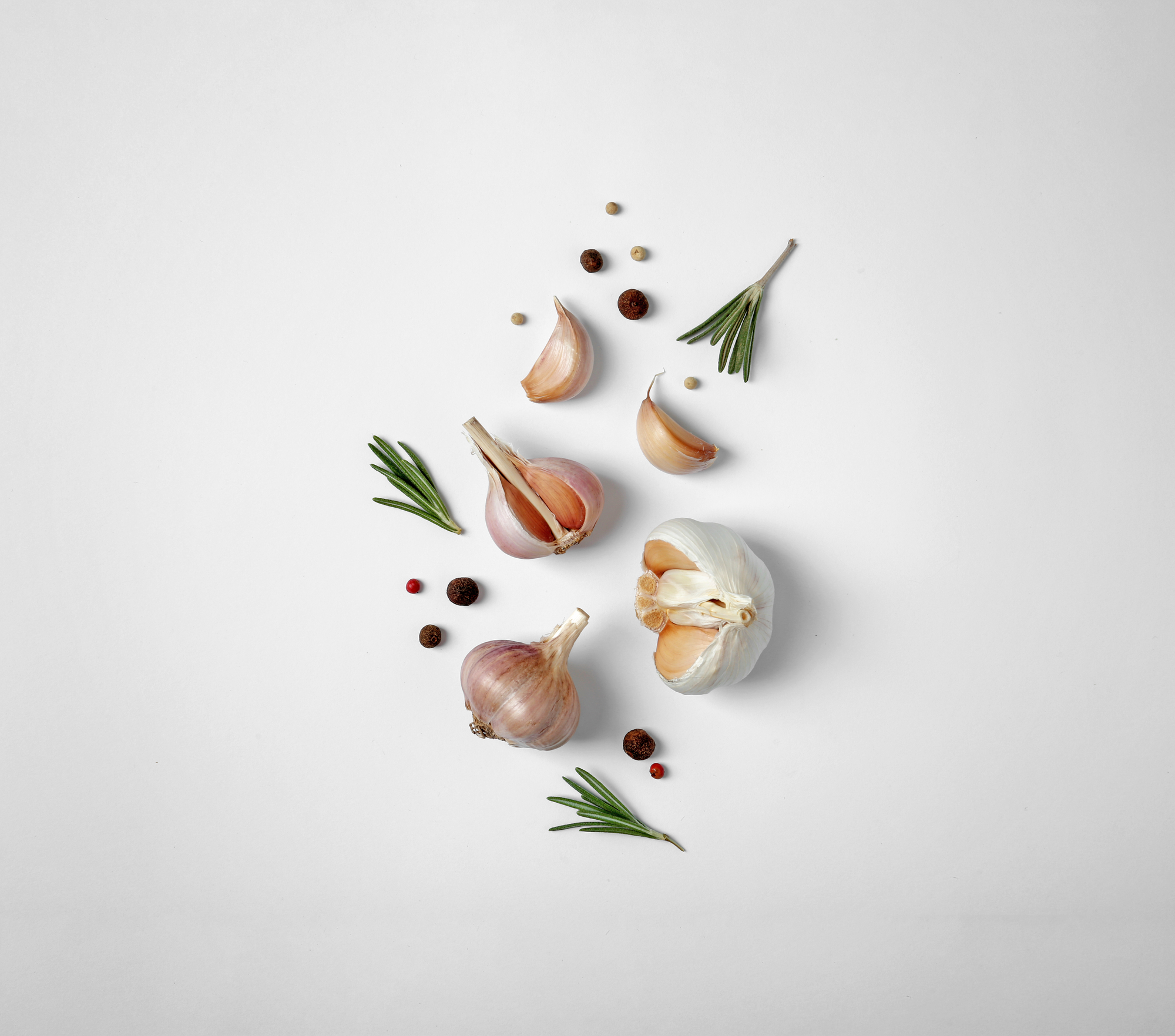 Composition with garlic, pepper and rosemary on white background