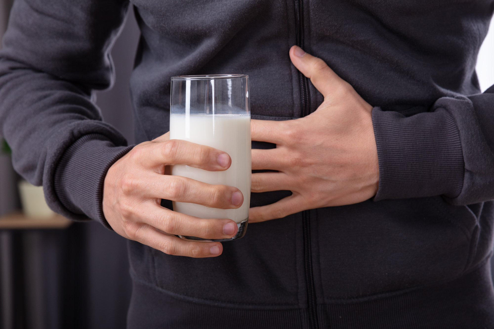 Man Having Stomach Pain Holding Glass Of Milk
