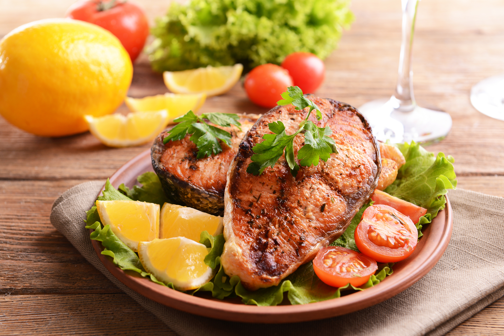 Tasty baked fish on plate on table close-up