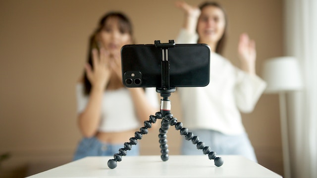 two girls shoot a dance on a smartphone