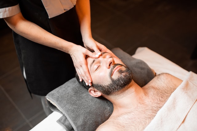 Bearded man receiving a facial massage