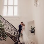 bride and groom kissing on the stairs