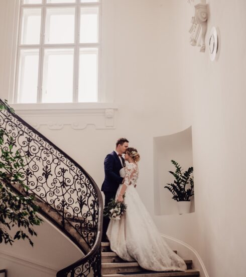 bride and groom kissing on the stairs