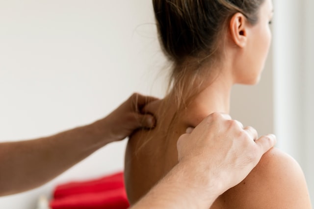 masseur man's hands during back massage for his woman client