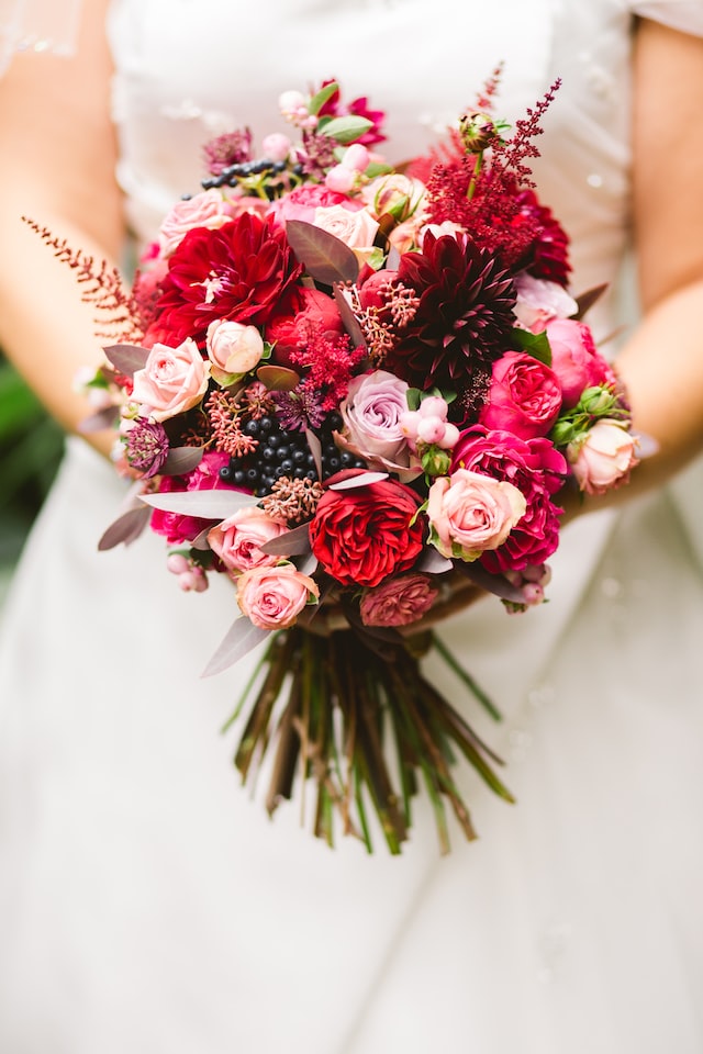 person in wedding dress holding the flowers