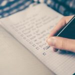 Nutrition Plan - person writing bucket list on book