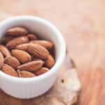 Nutrition Supplements - shallow focus photography of almonds in white ceramic bowl