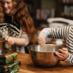 Cooking - woman in black and white striped long sleeve shirt holding stainless steel bowl