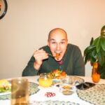 Meals - a man sitting at a table with a plate of food in front of him