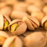 Nutrition - a pile of pistachio nuts sitting on top of a table