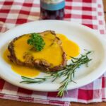 Foods - Cooked pork chop on round white ceramic plate