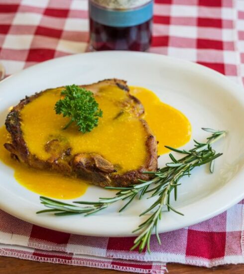 Foods - Cooked pork chop on round white ceramic plate