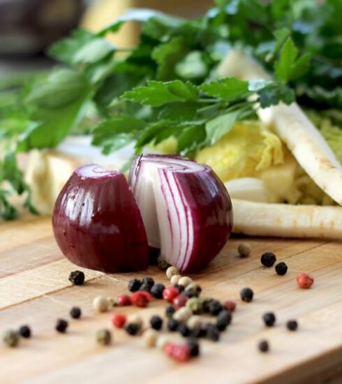 Nutrition - red onion on brown wooden chopping board