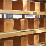 Foods - a shelf filled with lots of different types of bread