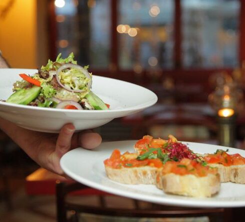 Restaurants - Person Holding Pastry Dishes on White Ceramic Plates