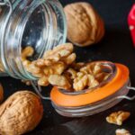 Superfoods - Walnuts in a jar with a knife and spoon