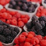 Superfoods - Fresh raspberries and blackberries at a farmers market