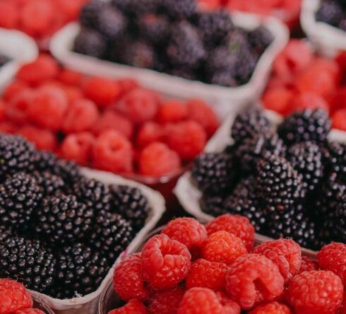 Superfoods - Fresh raspberries and blackberries at a farmers market