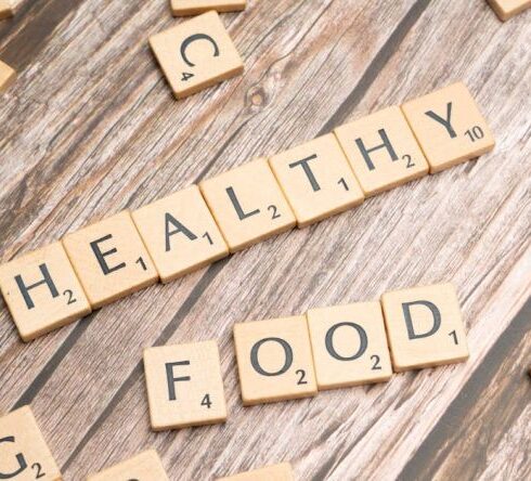 Superfoods - Healthy food on wooden table with scrabble letters