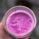 Wellness Diet - A person holding a glass of purple juice