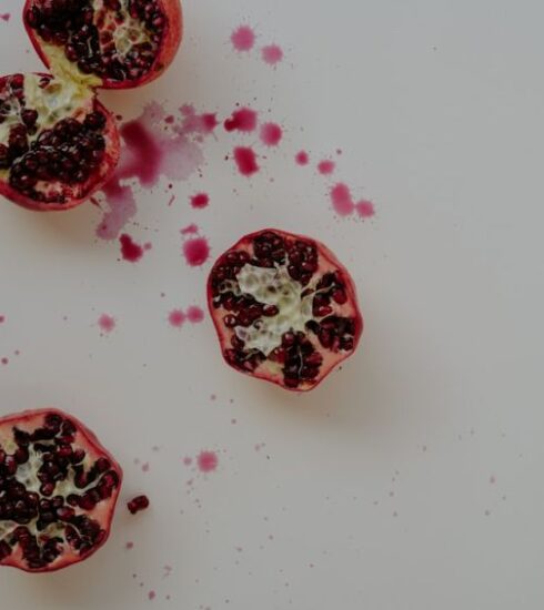 Superfoods - a cut open pomegranate on a white surface