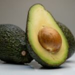 Superfoods - an avocado cut in half on a table