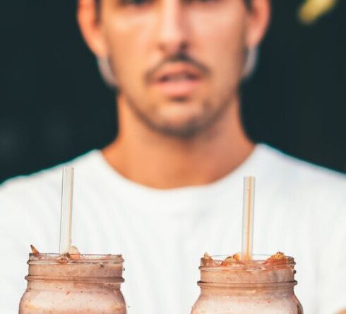 Diet - Man Wearing White Crew-neck T-shirt and Fitted Cap Holding Two Glass Jars