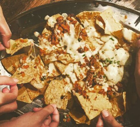 Snacks - Close-up Photography of People Picking Nachos Chips