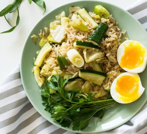 Diet - Fried Rice With Poached Egg, Zucchini, And Celery on Round Green Ceramic Plate