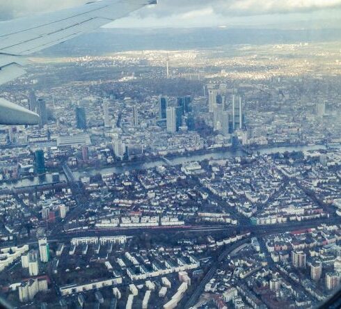 Traveling - Airplane Windowpane Showing City Buildings