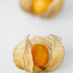 Diets - Two Brown Round Fruits on White Textile