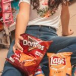 Snacks - Woman Sitting on Beige Floor Tile