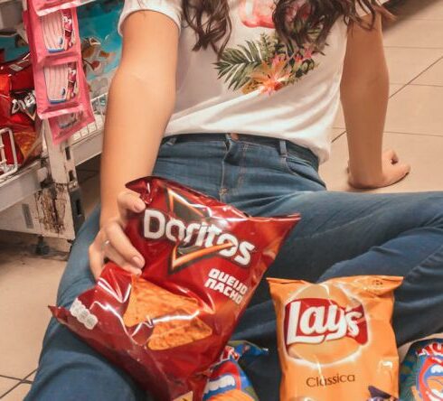 Snacks - Woman Sitting on Beige Floor Tile