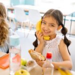 Snacks For Kids - Girls Smiling while Eating Snack during Their Break Time