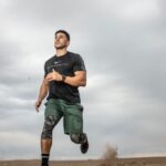 Workout - Man Running on Sand Field