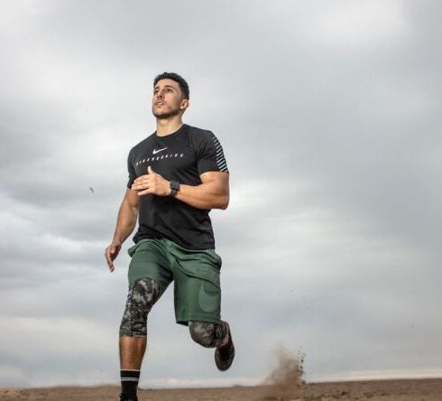 Workout - Man Running on Sand Field