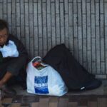 Hunger - Man Sitting Beside Wall