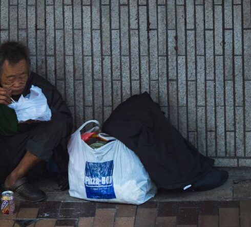 Hunger - Man Sitting Beside Wall