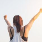 Wellness - Woman Wearing Black Bra and White Tank Top Raising Both Hands on Top