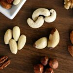 Nuts - Variety of Brown Nuts on Brown Wooden Panel High-angle Photo