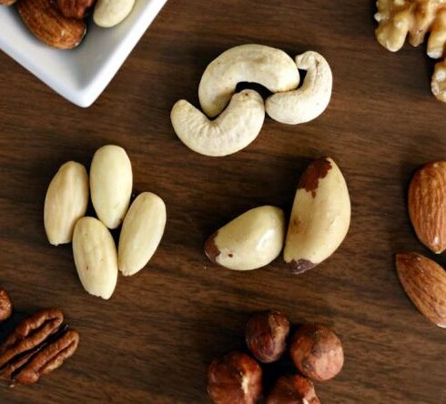 Nuts - Variety of Brown Nuts on Brown Wooden Panel High-angle Photo