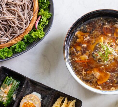 Meals - A table with bowls of noodles, rice and other food