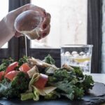 Diet - Person Pouring Dip on Vegetable Salad