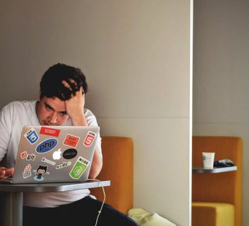 Stressful - Man in White Shirt Using Macbook Pro