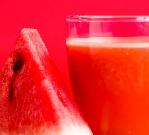 Diet - Watermelon Shake Filled Glass Cup Beside Sliced Watermelon Fruit on Brown Surface