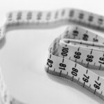 Diet - selective focus photography of tape measure