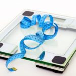 Diet - Blue Tape Measuring on Clear Glass Square Weighing Scale