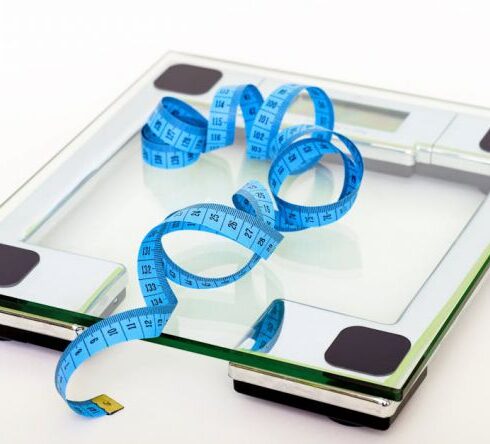 Diet - Blue Tape Measuring on Clear Glass Square Weighing Scale